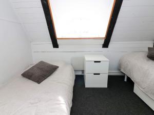 a bedroom with two twin beds and a window at Tranquil Waterfront Cottage-By Traum in Hadsund