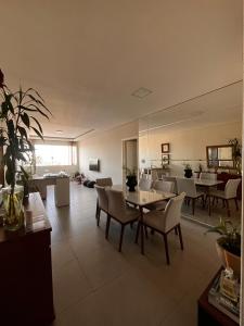 a living room with a table and chairs at Apto Moderno no Centro - Completo e Confortável in Americana