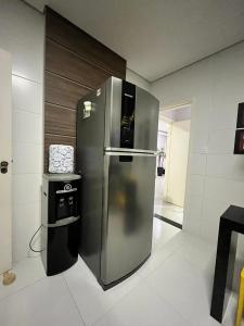 a large stainless steel refrigerator in a kitchen at Apto Moderno no Centro - Completo e Confortável in Americana
