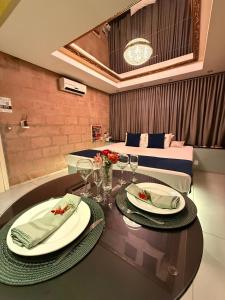 a room with a bed and a table with plates and glasses at Hotel Motel Paradiso - Panambi-RS in Tabapira