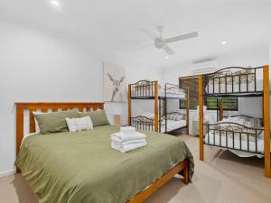 a bedroom with a bed with four bunk beds at Elsinor 4 in Mulwala +14 photos