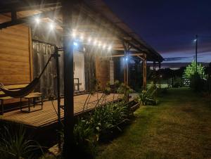 a house with a hammock on a deck at night at CASA CONTENEDOR in Necochea