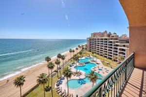 a view of the beach and the ocean from the balcony of a resort at Penthouse Beachfront at Sonoran Spa in Puerto Peñasco