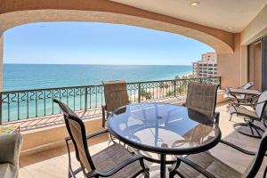 a balcony with a glass table and chairs and the ocean at Penthouse Beachfront at Sonoran Spa in Puerto Peñasco
