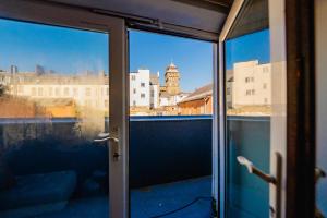 a view of a city through a glass door at Modern 2 BR 2 Bath Flat With Balcony & Fast WiFi in Cardiff
