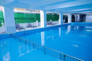 a swimming pool with blue water in a building at The Residence -Juction Mall in Nairobi