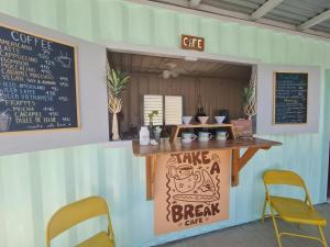 a coffee shop with a counter with a chalkboard at Hotel Marea in San Juan del Sur