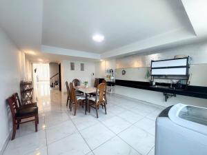a kitchen with a table and chairs in a room at Spacious 5BR Townhouse in Central Phnom Penh in Phnom Penh +32 photos