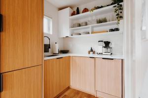 a kitchen with white walls and wooden cabinets at Camp Alta in Packwood
