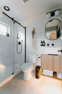 a bathroom with a toilet and a glass shower at Camp Alta in Packwood +8 photos