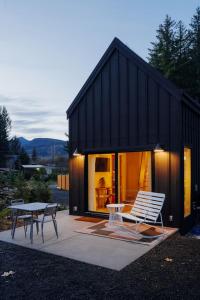 a black house with a table and chairs in front of it at Camp Alta in Packwood