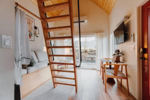 a wooden spiral staircase in a room with a table at Camp Alta in Packwood