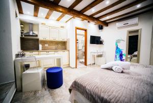 a bedroom with a bed and a kitchen with a sink at Apartment Genius Loci in Split +22 photos