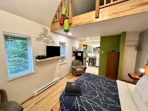 a room with a bed and a living room at Great Cabin In Close To Walking Trails And Beaches - 13T in Ucluelet
