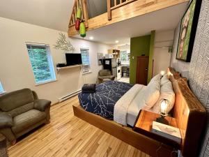 a bedroom with a bed and a living room at Great Cabin In Close To Walking Trails And Beaches - 13T in Ucluelet