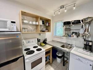 a kitchen with a stove and a sink at Great Cabin In Close To Walking Trails And Beaches - 13T in Ucluelet +12 photos