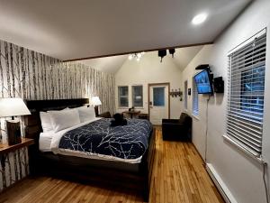 a bedroom with a bed and a television in it at Cozy Cabin Near Walking Trails And Beaches! in Ucluelet +8 photos