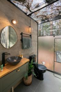 a bathroom with a sink and a mirror at Lohma Nature in Gramado