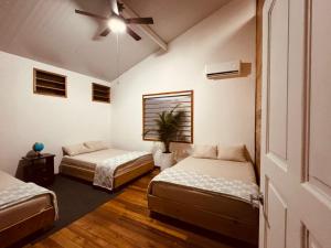 a room with two beds and a ceiling fan at Hotel Mauka Boutique Villas in Cocles +32 photos