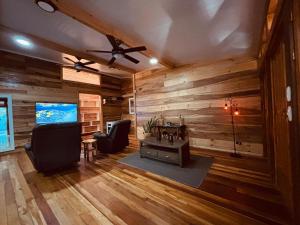 a living room with wooden walls and a table and chairs at Hotel Mauka Boutique Villas in Cocles