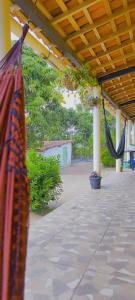a patio with a hammock hanging from a roof at Sítio de Vavá in Gravatá +11 photos