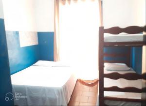 a bedroom with two bunk beds and a window at Hotel e Pousada das Goianas in Santos +25 photos