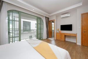 a bedroom with a bed and a flat screen tv at Opus Villas Tropical Phu Quoc in Phú Quốc +172 photos