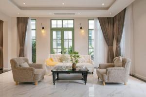 a living room with two chairs and a table at Opus Villas Tropical Phu Quoc in Phú Quốc