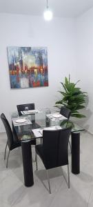 a dining room with a table and chairs and a painting at Le Nide d'azrou in Azrou