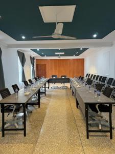 a large conference room with long tables and chairs at Grand Montis Hotel in Abbottabad