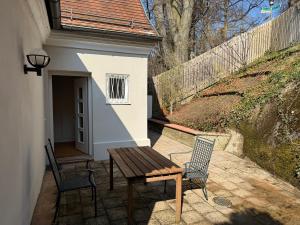 a wooden table and two chairs on a patio at Gabi`s Villa am Hang in Bad Aibling +38 photos