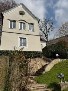 a white house with stairs in front of it at Gabi`s Villa am Hang in Bad Aibling