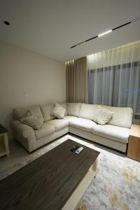a living room with a couch and a table at Elite Alsultan in Al Khobar