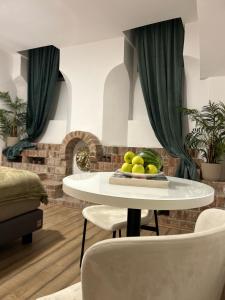 a white table with a plate of fruit on it at Golden Residence in Vienna