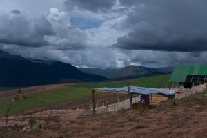 a building with a green roof on top of a hill at Camping tres nevados in Urubamba