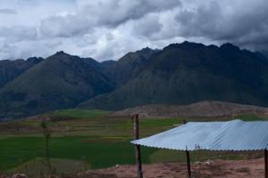 a view of a mountain range with a white roof at Camping tres nevados in Urubamba