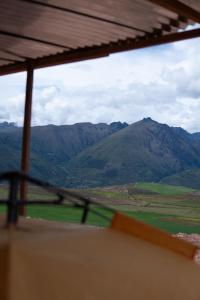 a view of a mountain range from a window at Camping tres nevados in Urubamba +2 photos