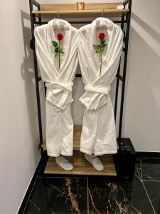 a couple of white robes hanging on a rack at Escale 53 A 5 min aéroport Orly in Athis-Mons +39 photos