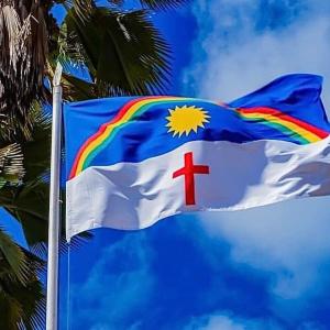 a flag with a rainbow and a cross on it at casa boa vista in Recife