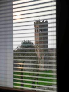 a view of a tall building through a window at Dimora Porta Vicenza-Montagnana in Montagnana