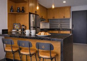 a kitchen with a counter with a plate of food on it at Modern apartment with pool , Riviera Nayarit in Naranjo