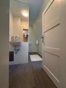 an open door leading to a bathroom with a sink at Villa Weisser Berg in Neuwied