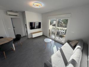 a living room with a couch and a table at Apartment A&T La Mata in La Mata