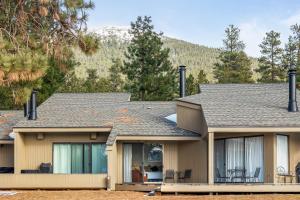 a house with mountains in the background at Lodge Room 015 in Black Butte Ranch