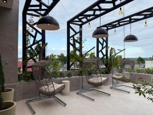 a group of chairs sitting on a patio at Posada Itza Peten in Santa Elena