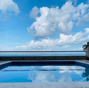 a swimming pool with the sky in the background at Vitória Marina Flats in Salvador