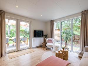a living room with a couch and a table at Het Hertenpad in Hattemerbroek