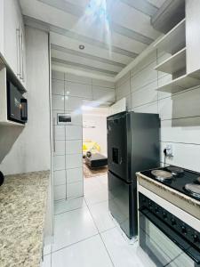 a kitchen with a black refrigerator and a stove at Modern Comfort, Easy Access Everywhere in Vanderbijlpark