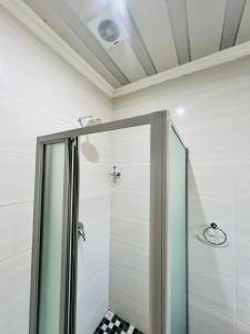 a shower with a glass door in a bathroom at Modern Comfort, Easy Access Everywhere in Vanderbijlpark