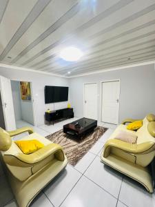 a living room with two beds and a flat screen tv at Modern Comfort, Easy Access Everywhere in Vanderbijlpark